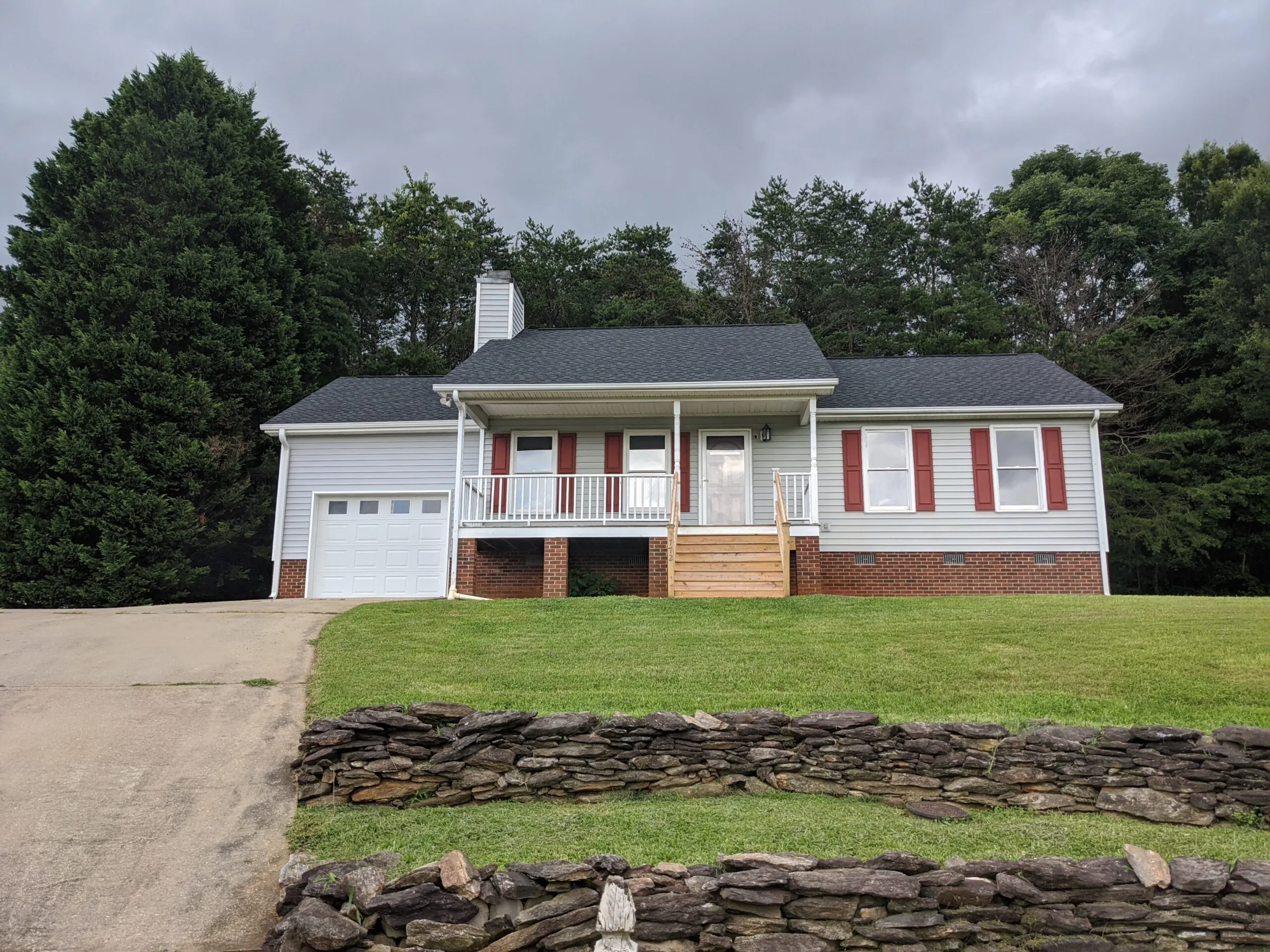 House exterior with porch and red shutters